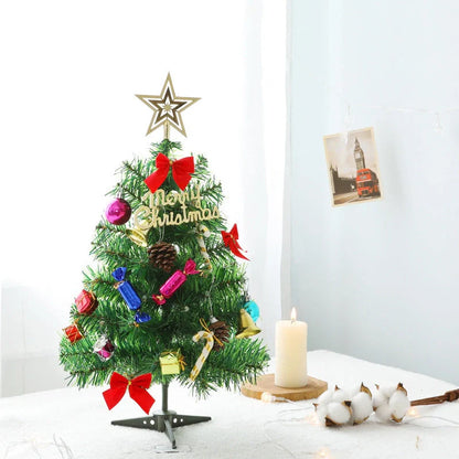 Mini Christmas tree with multi-color LED lights and festive accessories on a desktop