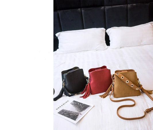 A stylish frosted tassel bucket bag with interior pockets and a versatile shoulder strap design