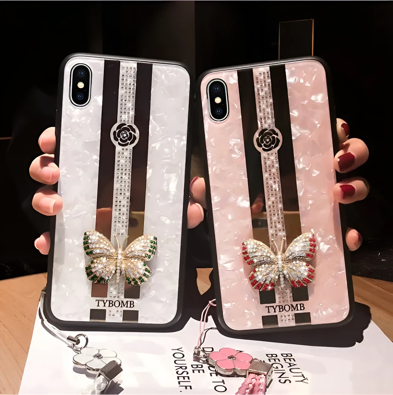 Clear acrylic iPhone case with Swarovski crystal butterfly design and central mirror in purple.