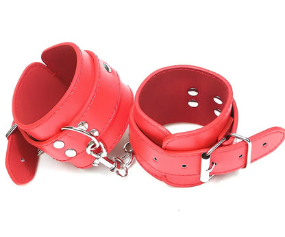 Black PU leather BDSM handcuffs showing adjustable buckle and 20cm connecting chain