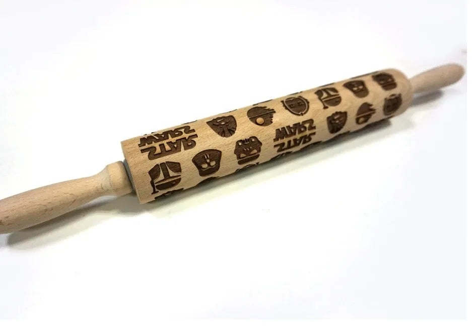 Wooden rolling pin with engraved Christmas patterns including reindeer and snowflakes on a 45cm long barrel.