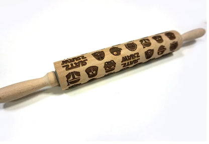 Wooden rolling pin with engraved Christmas patterns including reindeer and snowflakes on a 45cm long barrel.