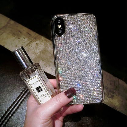 Silver silicone phone case with sparkling diamond decoration for various iPhone models.