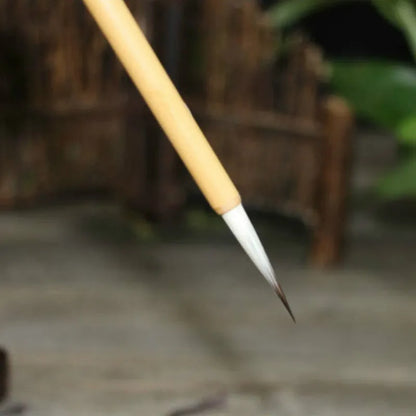 Four traditional Chinese calligraphy brushes with thin gold bodies and pine branch design