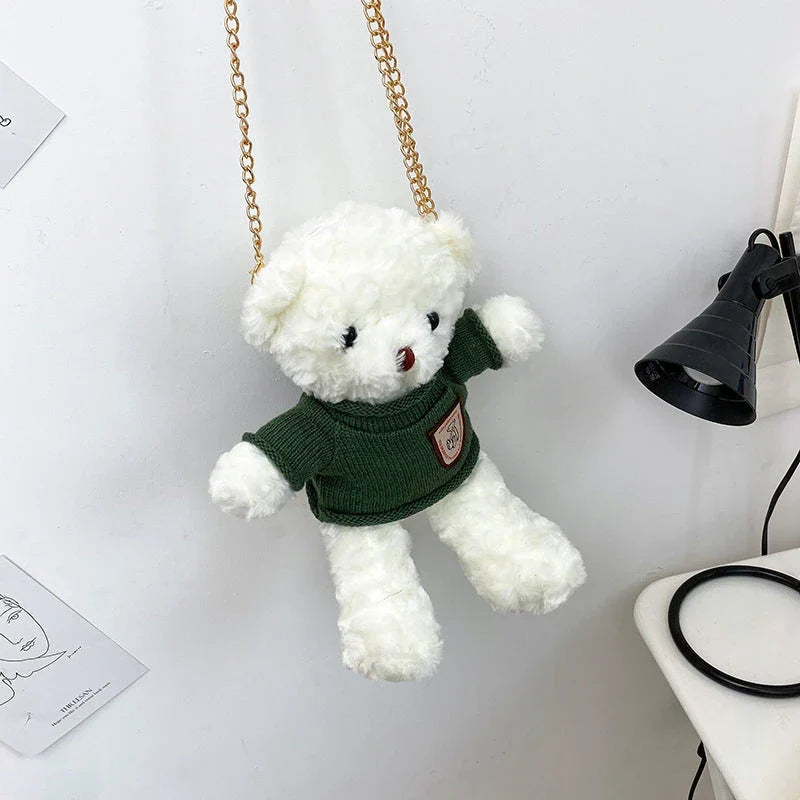 A plush teddy bear crossbody messenger bag with an adjustable shoulder strap and a zippered interior pocket for convenient storage.