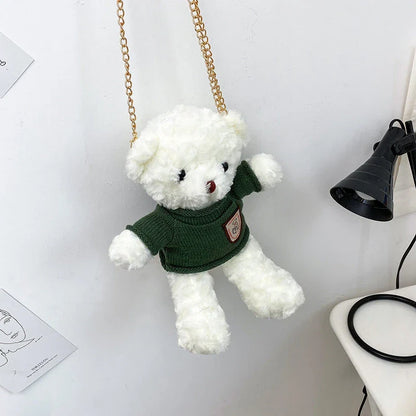 A plush teddy bear crossbody messenger bag with an adjustable shoulder strap and a zippered interior pocket for convenient storage.