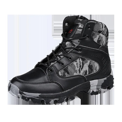 Men's black and camouflage high-top hiking shoes with PU upper and metal eyelets on a rocky outdoor path.