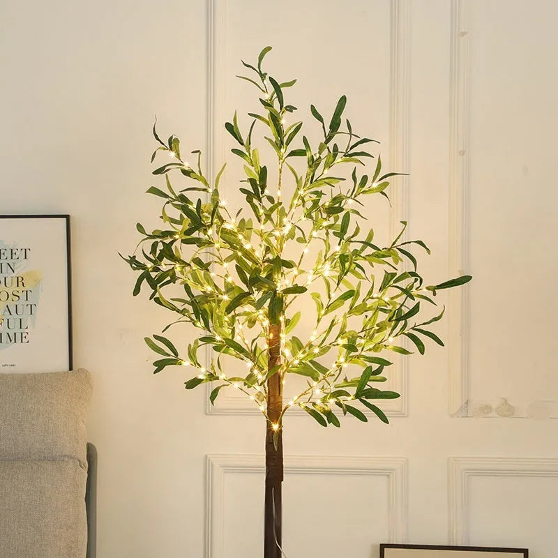 1.8 metre tall artificial olive leaf tree lamp with warm white LED lights in courtyard setting