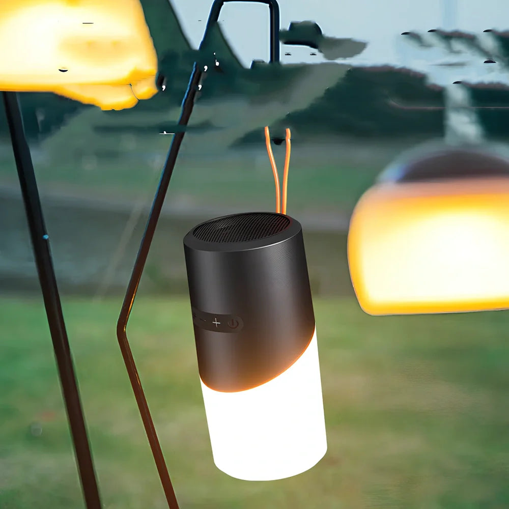 Black portable Bluetooth speaker with RGB lights, iron mesh covering, and compact circular design for outdoor audio