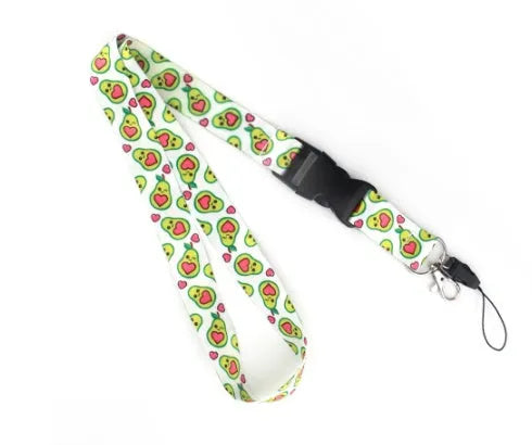 Green avocado cartoon print on a white polyester phone lanyard with a silver buckle.