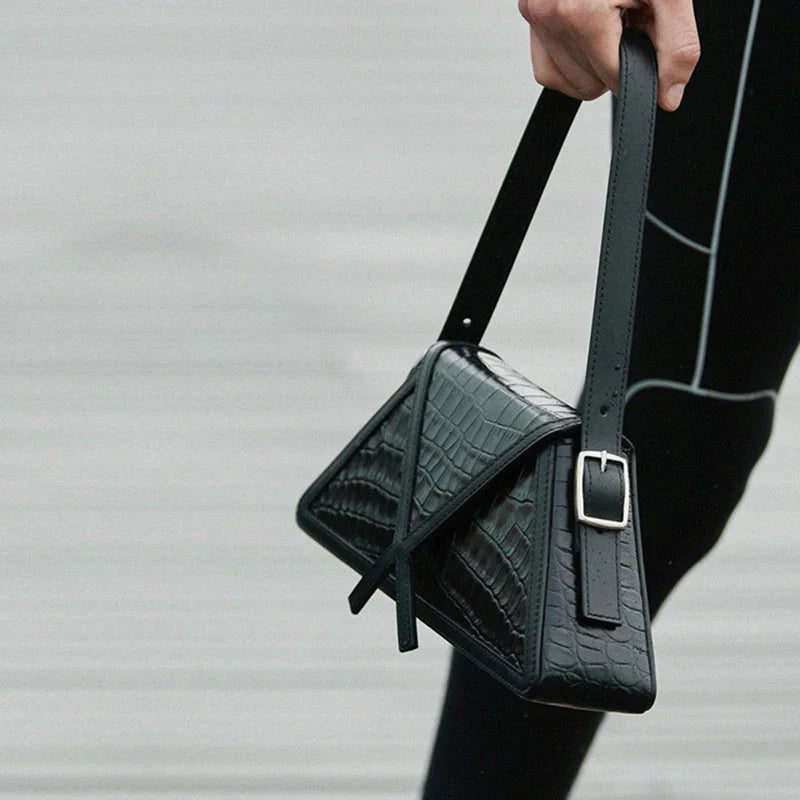 Stitching contrast trapezoid shoulder bag in black, beige, blue, and orange with magnetic buckle closure