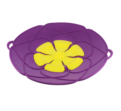 Green silicone spill stopper pan lid on cooking pot showing flexible edges and steam vent