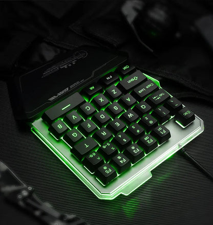 Black one-handed keyboard with RGB backlight and 1.8-metre USB cable on a desk