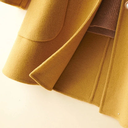 Women's black wool mid-length coat with doll collar and pearl buckle, showing double-faced fabric and 65cm length.