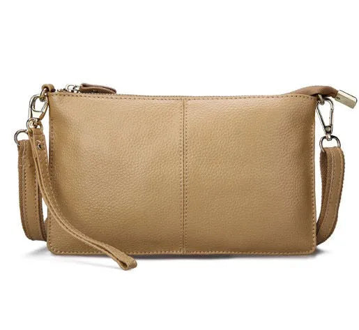 Lady's cowhide slant bag in apricot colour showing front view with strap and compact 24 cm size.