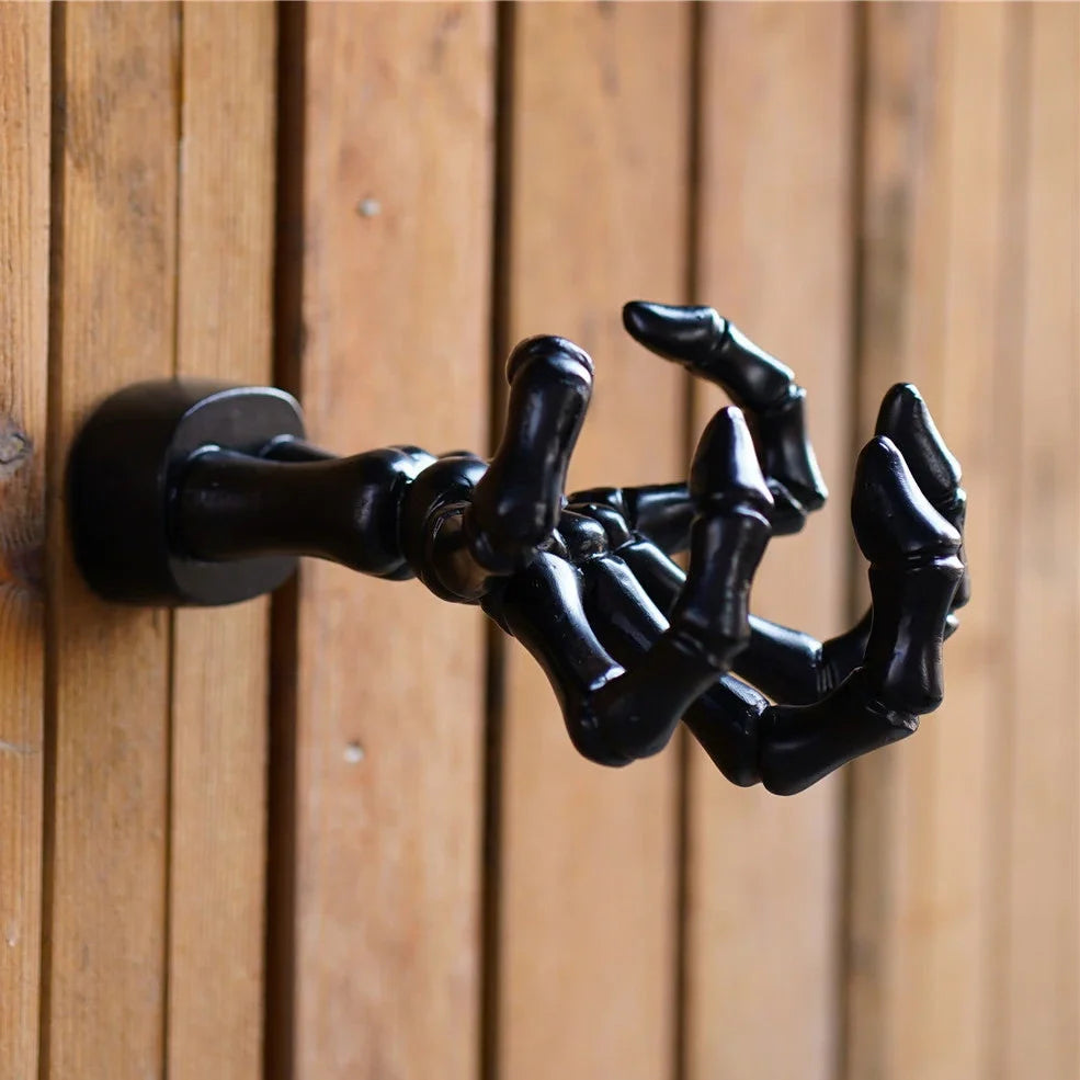 Black skeleton hand wall hook with articulated fingers for hanging keys and jewellery