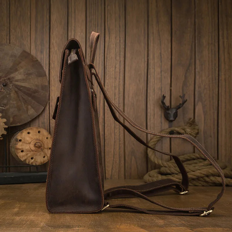 Genuine leather men's casual travel bag in dark brown, featuring retro European and American style with double shoulder straps, a soft carry handle, and under 20L capacity for daily use and travel.