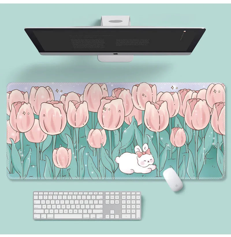 Large floral pattern mouse pad on a wooden desk with a computer mouse.