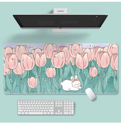 Large floral pattern mouse pad on a wooden desk with a computer mouse.