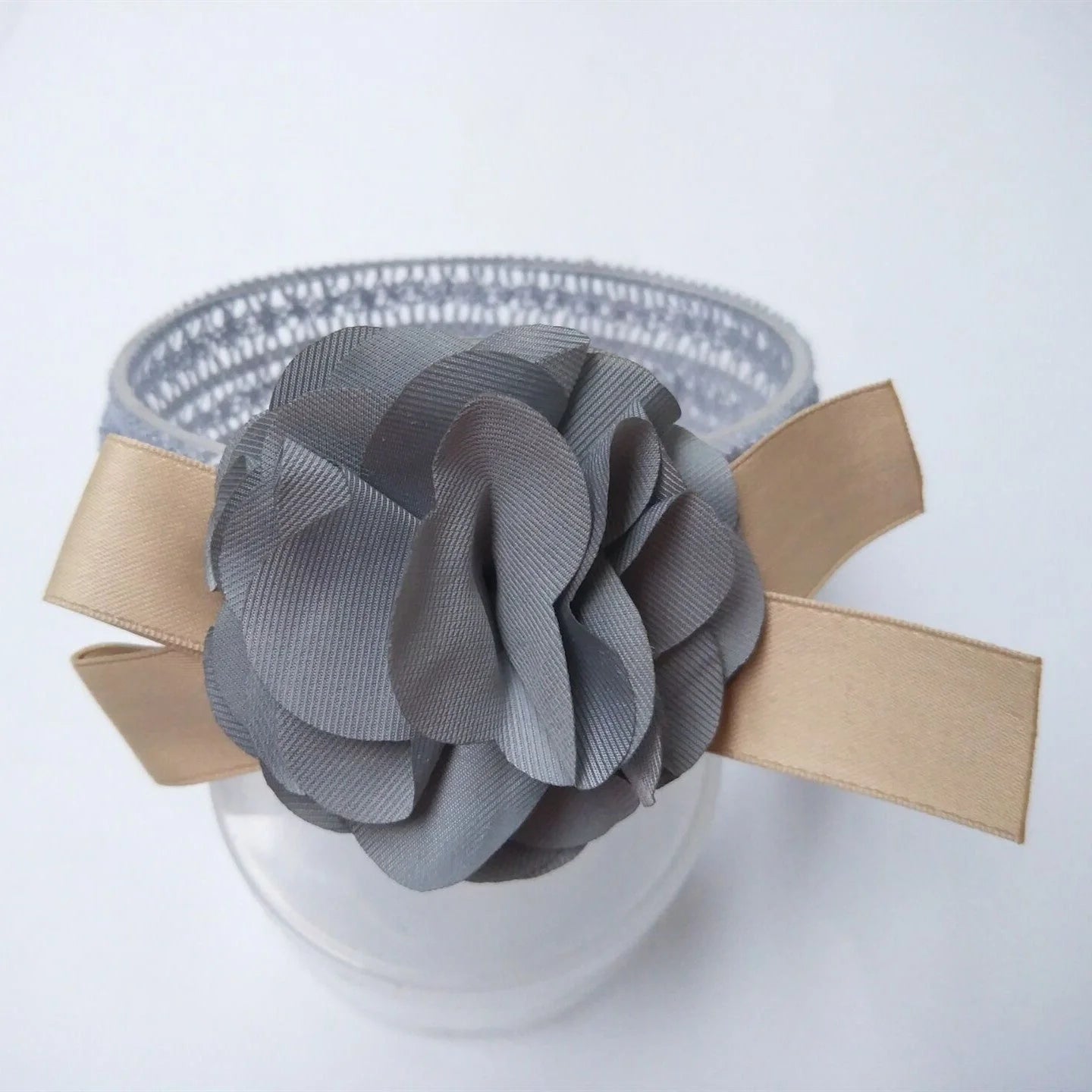 A charming flower headband for babies, featuring a delicate floral design and adjustable fit for a comfortable, stylish accessory.