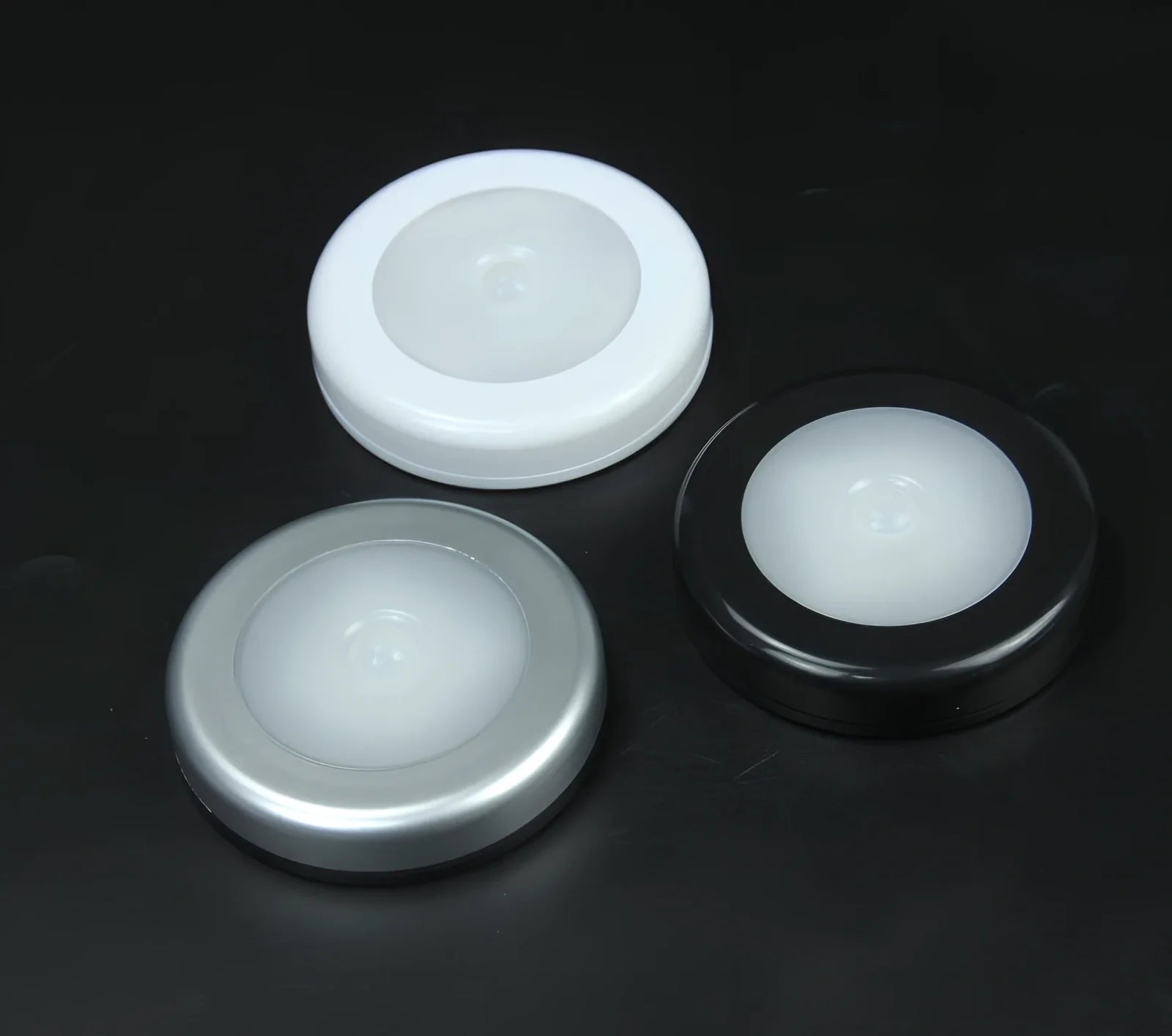White motion-sensing LED cabinet lamp with magnetic back for wireless installation