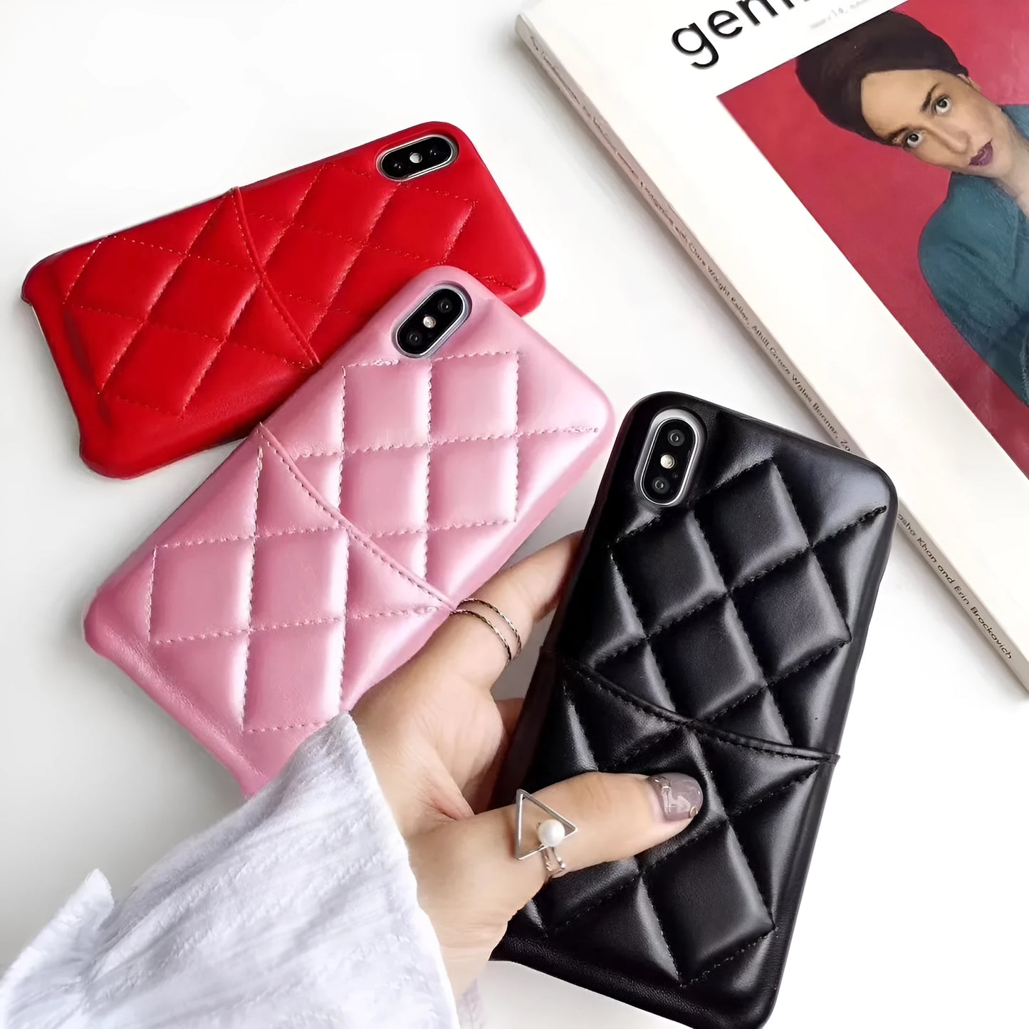 Leather mobile phone case for iPhone XS Max in black, pink, and red colour options.