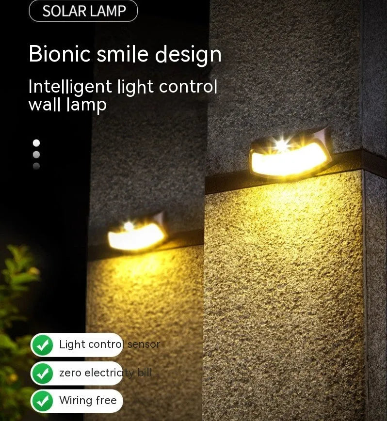 Solar outdoor wall lamp with smiling face design measuring 153mm × 76mm × 38mm for garden lighting