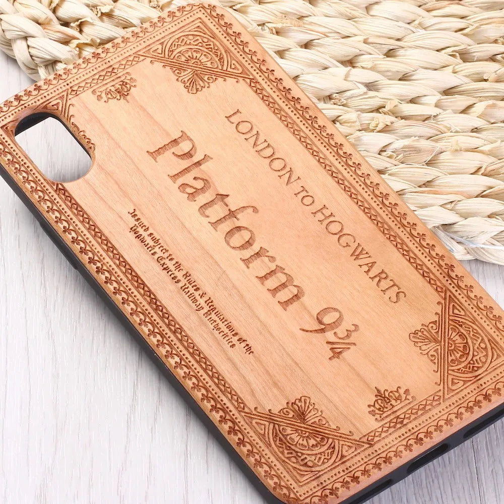 Wooden iPhone case with a laser-carved floral design and a black TPU bumper, shown fitted on an iPhone.
