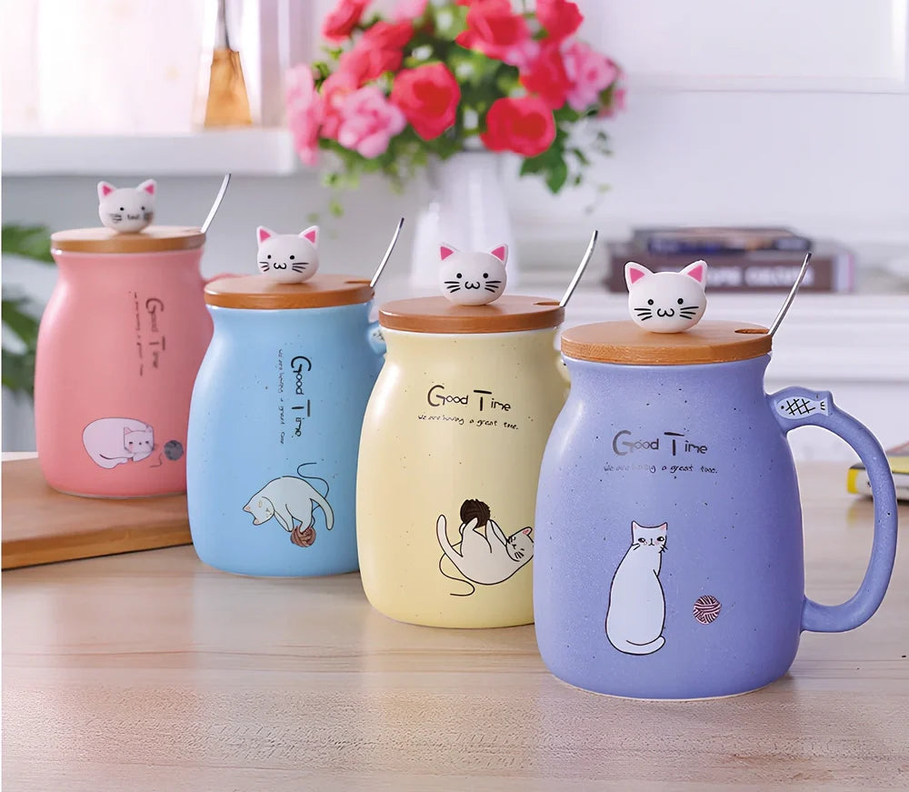 Pink ceramic mug with cartoon cat design, wooden lid, and stainless steel spoon on table
