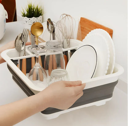 Grey folding kitchen dish rack showing collapsed flat position and separate utensil compartment