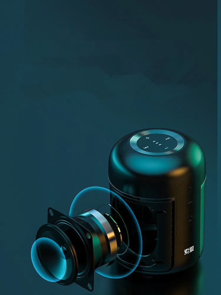 Small black portable Bluetooth speaker showing front grille and control buttons on a table.