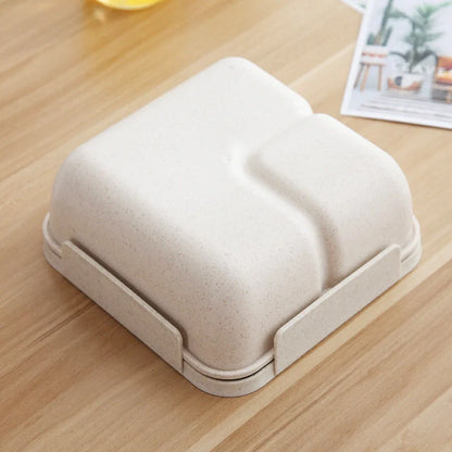 Japanese-style microwave-separated bento box in pink, green, and beige with spoon and chopsticks