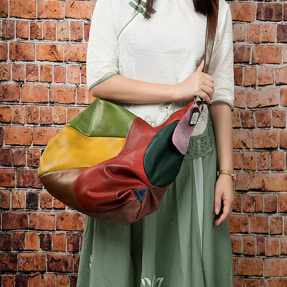Cowhide leather crossbody bag showing its size, suitable for carrying a 15-inch laptop and A4 documents.