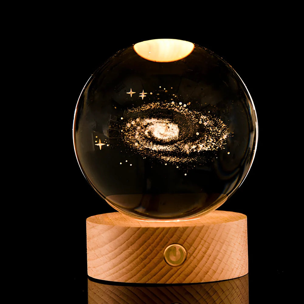 Transparent crystal ball with 3D laser inner carving of galaxy patterns on charging base