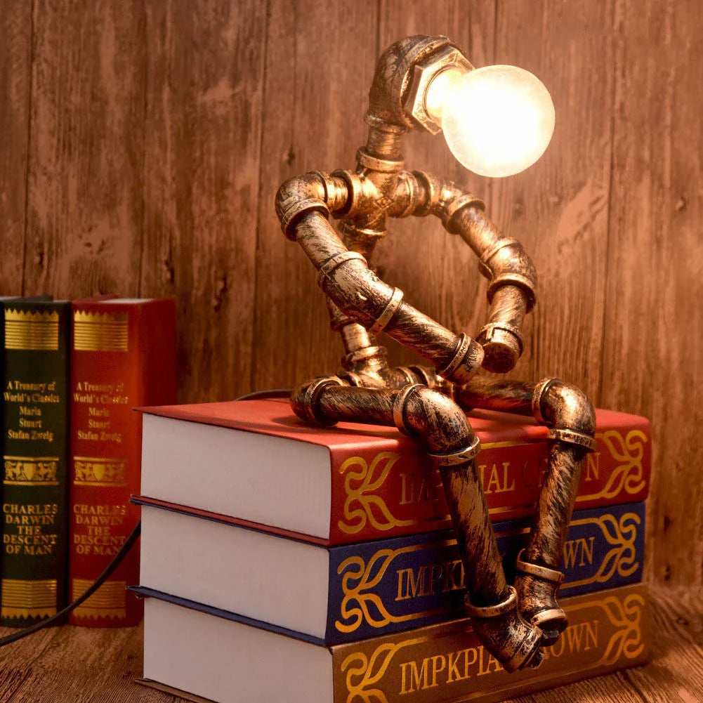 Vintage industrial iron pipe table lamp with soft, warm lighting and a green bronze finish