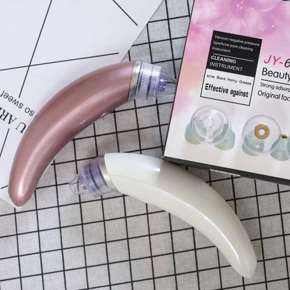 Electric blackhead suction instrument in rose gold and white colours for facial pore cleansing