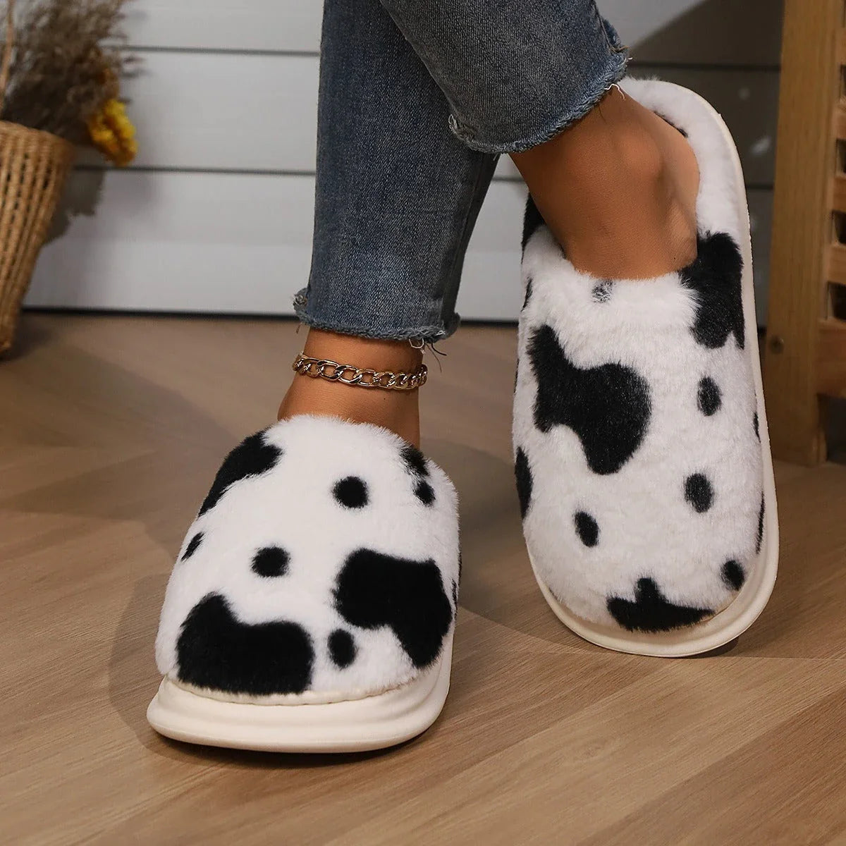 Cozy plush cow-print slippers with non-slip soles for comfortable indoor wear