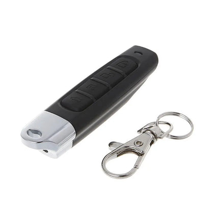 Rolling door remote control transmitter with compact black housing showing dimensions and control buttons