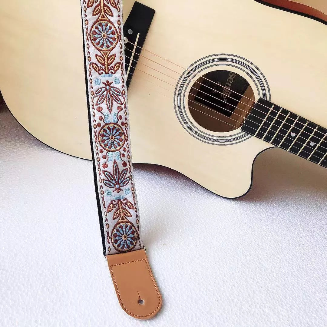 Adjustable embroidered guitar strap with durable webbing and intricate design