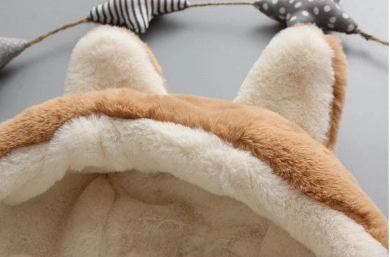 Baby wearing pink cotton coat with velvet accents, showing flocking fabric texture and cotton filling insulation