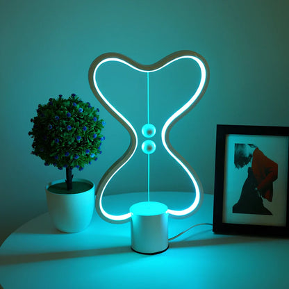 Balance lamp with suspended magnetic netballs and embedded LED lighting in frame