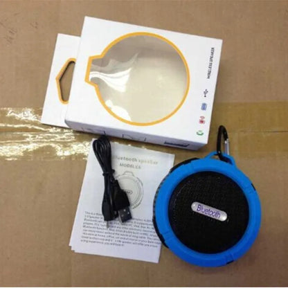 C6 portable waterproof Bluetooth speaker in multiple colours with a mounting clip attached.