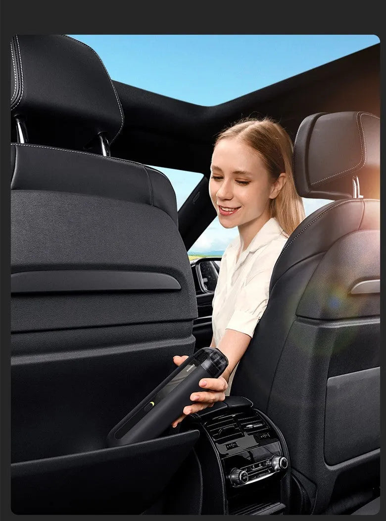 BASEUS handheld car vacuum cleaner in black with blowing hose attachment, showing compact size and dust bin