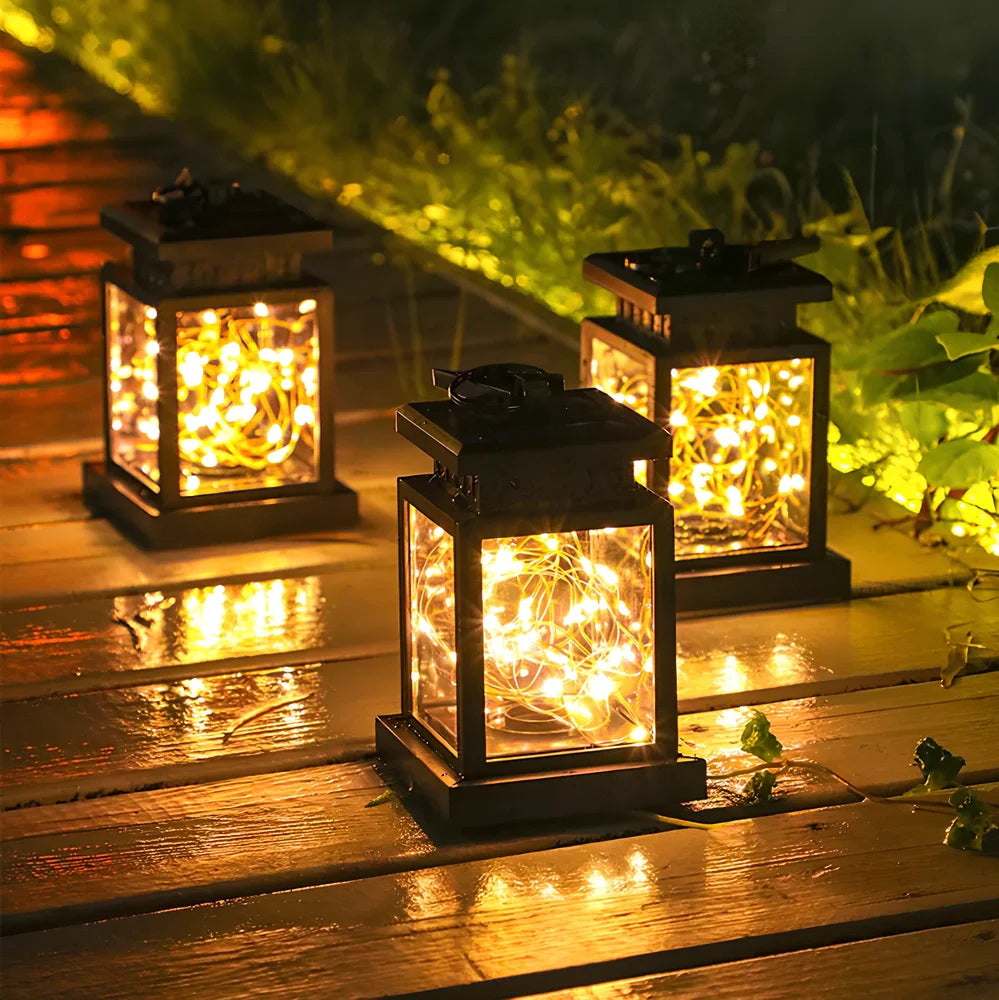 Black solar candle lamp with warm white LED illumination for outdoor gardens and patios