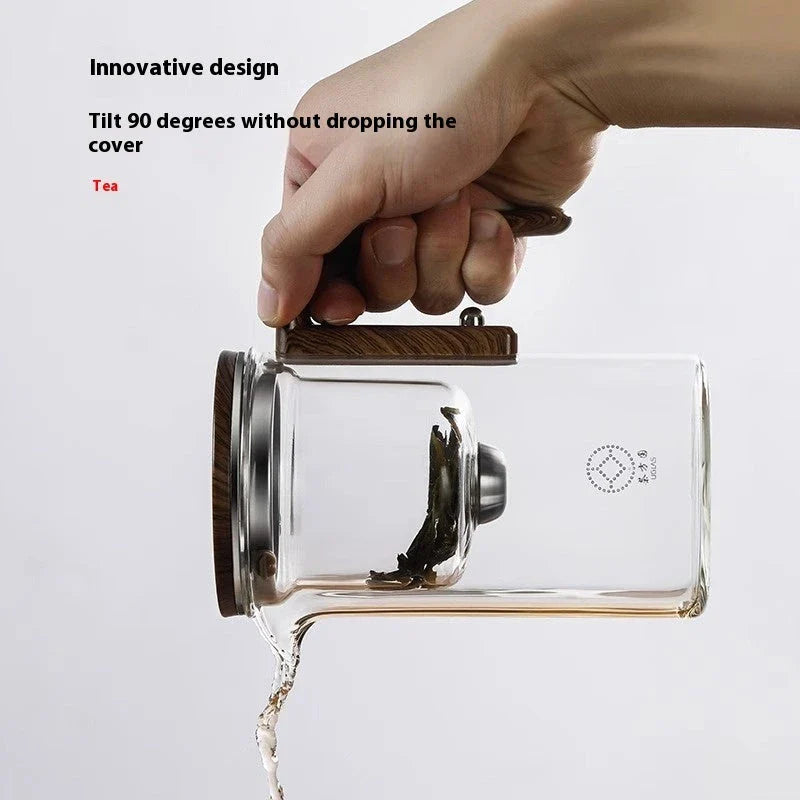 Elegant glass tea infuser pot with magnetic separation technology, wooden handle, and precise pouring spout