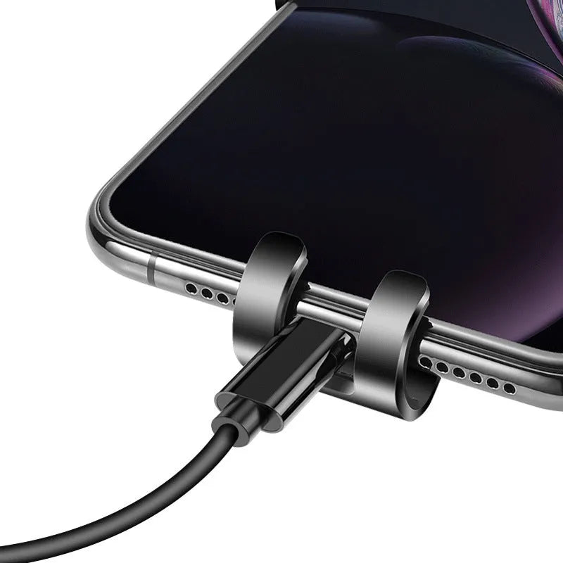 Black S4 ABS gravity mobile phone holder clipped onto a car air conditioning vent.