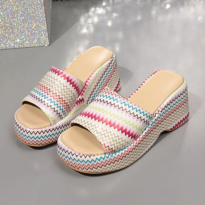 Women's beige wedge sandals with a blue wave print, thick rubber sole, and open fish mouth toe.
