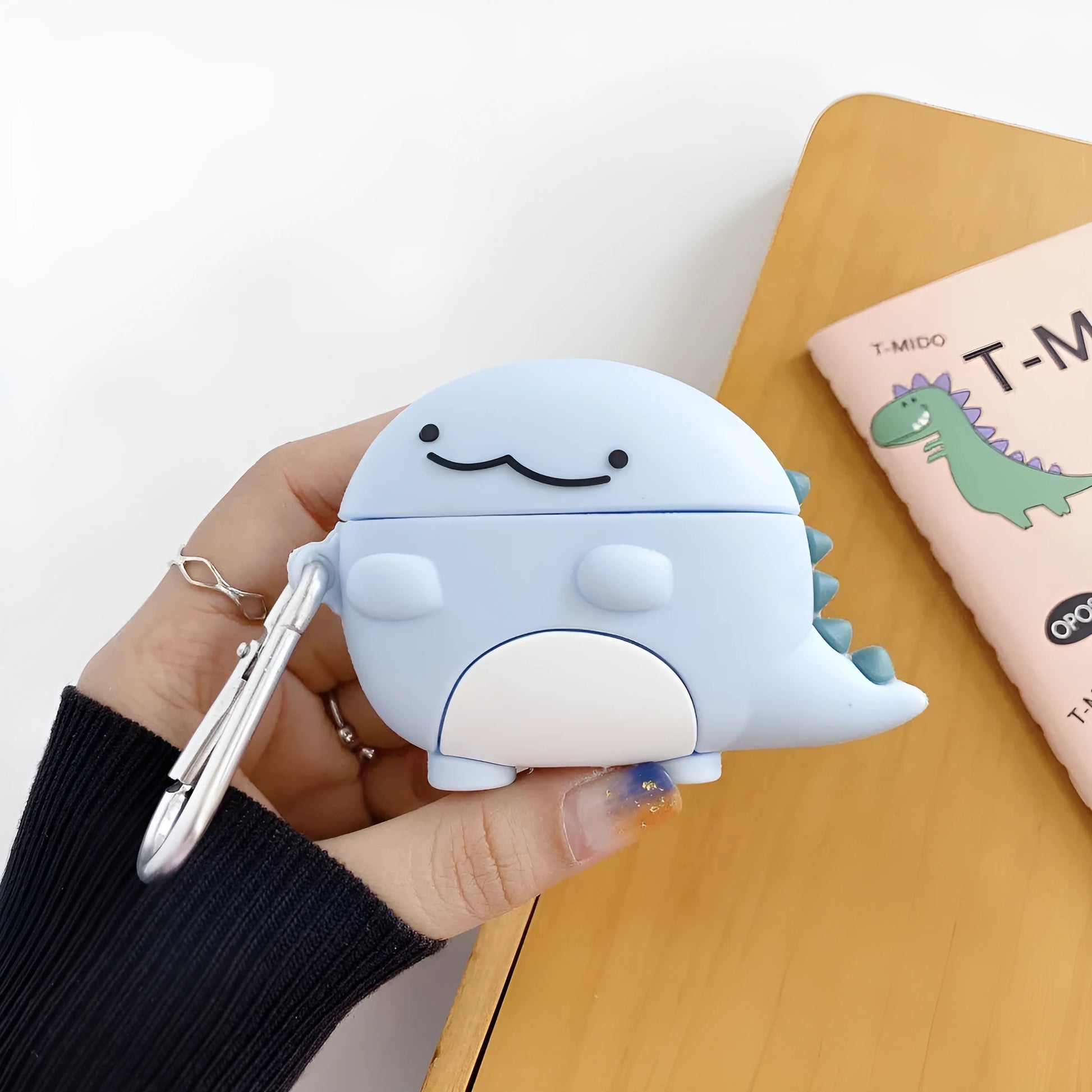 Blue silicone case for Apple AirPods featuring a cute baby dragon design.