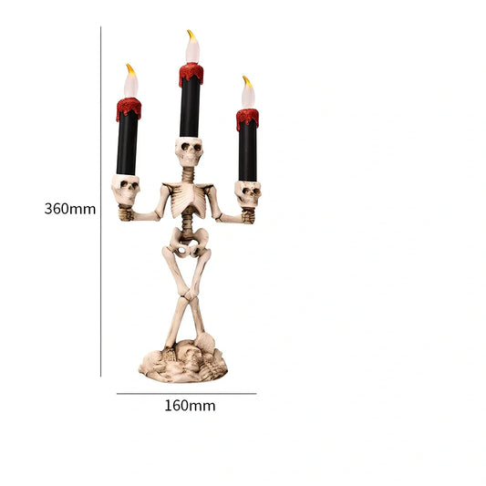 Halloween electronic candle with three skeleton decorations in gold colour, measuring 360mm tall
