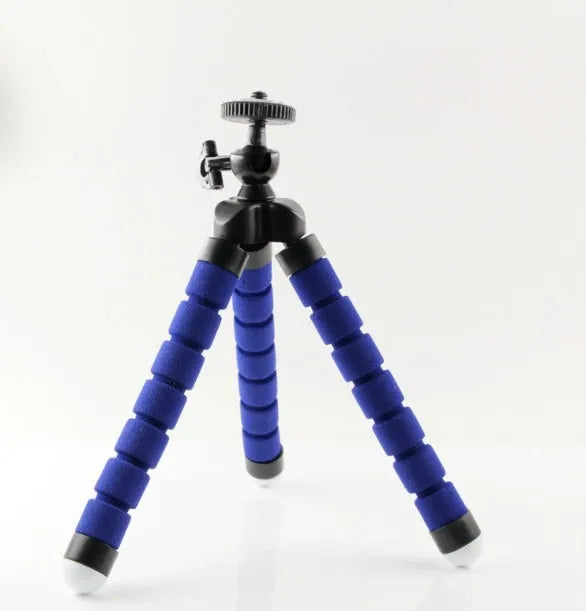 Black flexible octopus tripod stand wrapped around a branch holding a smartphone for angled video capture